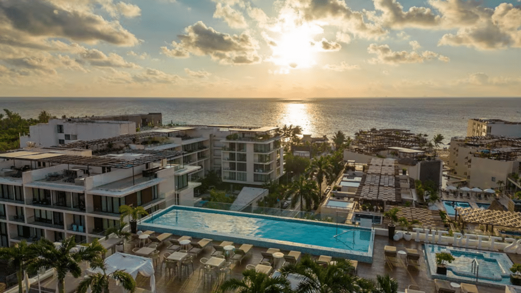 Rooftop infinity pool overlooking the Caribbean at sunset