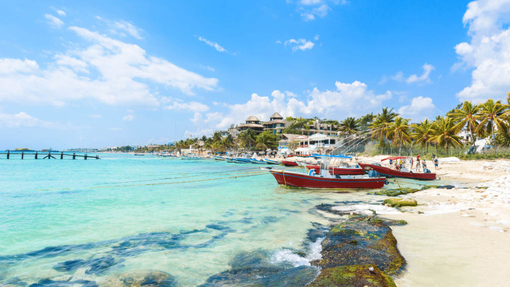 Colorful boats along a turquoise Caribbean beach