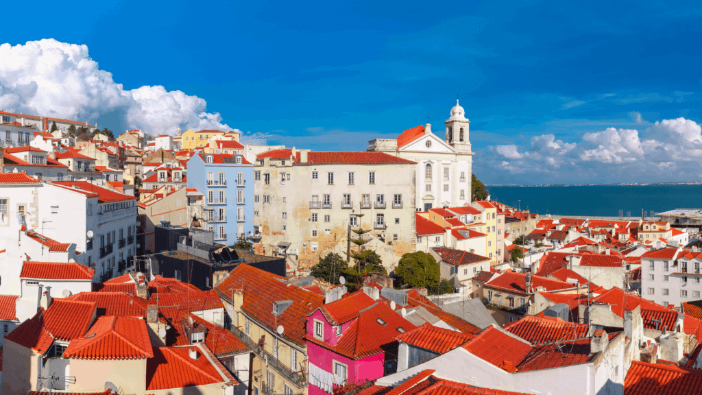 Colorful Alfama neighborhood rooftops overlooking the Tagus River
