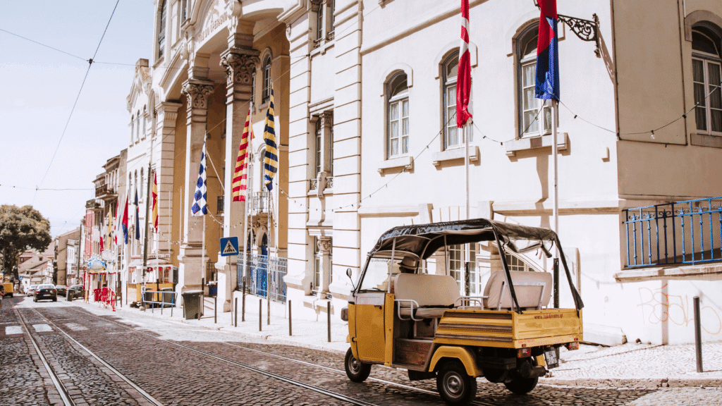 Tuk-tuk on a cobblestone street in Lisbon Portugal